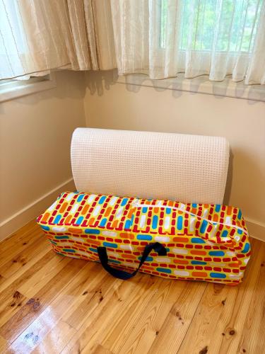 a bed sitting on the floor next to a couch at Charming Anatolian House in Çengelköy in Istanbul