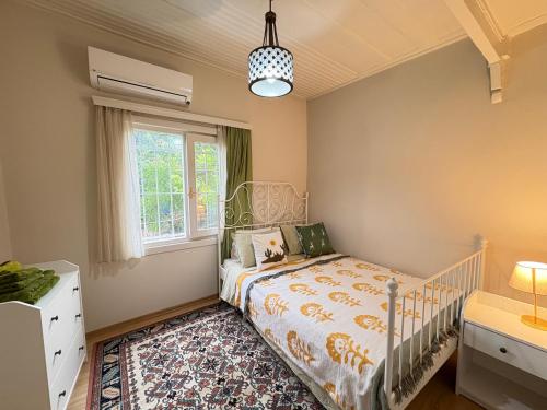 a bedroom with a crib and a window at Charming Anatolian House in Çengelköy in Istanbul