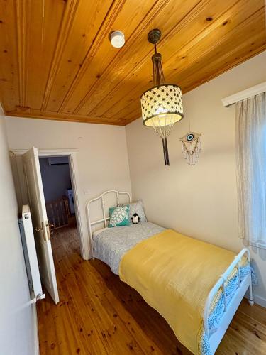 a bedroom with a bed and a wooden ceiling at Charming Anatolian House in Çengelköy in Istanbul