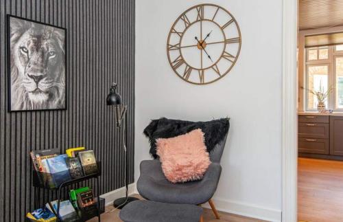 a room with a chair and a clock on the wall at Large Activity House With Free Access To A Water Park And Bowling 