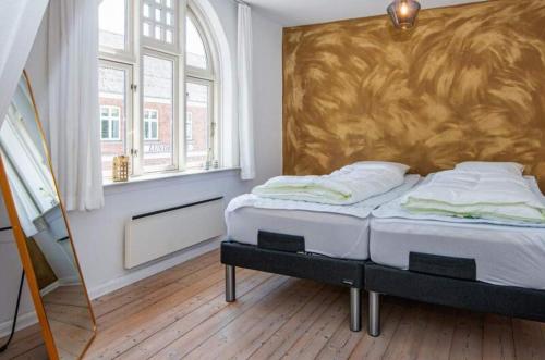 a bedroom with two beds and a large headboard at Large Activity House With Free Access To A Water Park And Bowling 