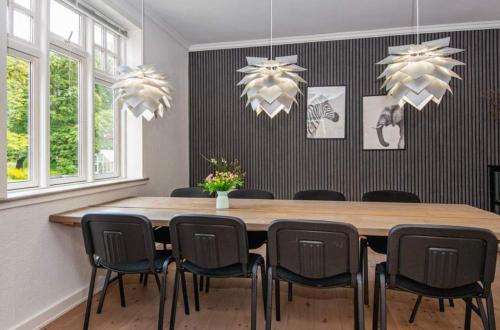 a dining room with a wooden table and chairs at Large Activity House With Free Access To A Water Park And Bowling 