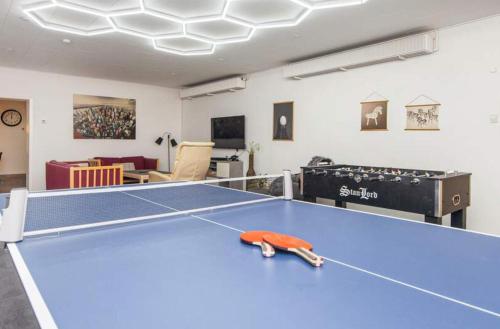a room with a blue ping pong table in it at Large Activity House With Free Access To A Water Park And Bowling 