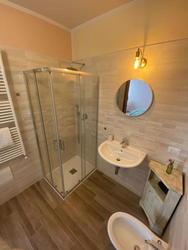 a bathroom with a shower and a sink and a mirror at Dal Maestro-Camere a Rivanazzano Terme in Rivanazzano