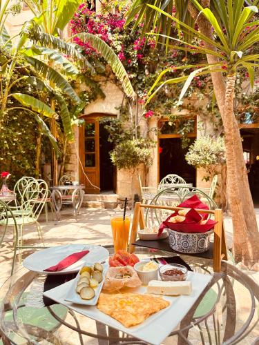a table with food and drinks on top of it at Casa Palma Boutique Hotel in Vlorë