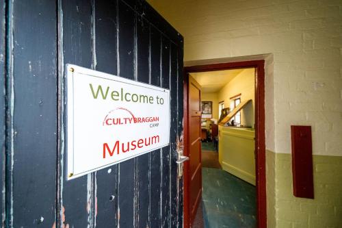 a welcome sign on the wall of a building at Cultybraggan Hut 37 in Comrie