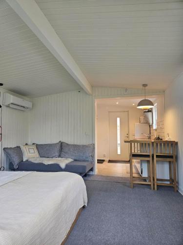 a living room with two beds and a couch at Central Åhus H Guest House in Åhus