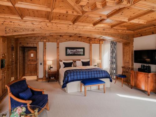 a large bedroom with a bed and a tv at Kulm Hotel St. Moritz in St. Moritz