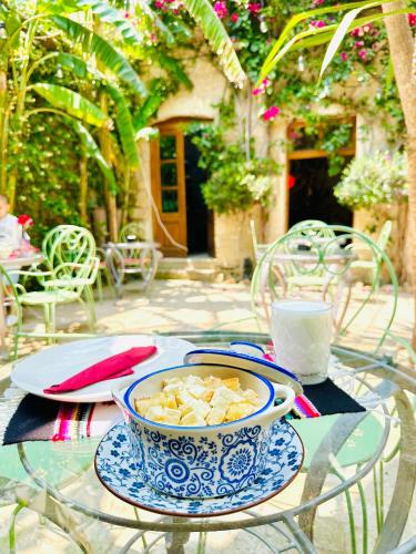 a glass table with a bowl of food on it at Casa Palma Boutique Hotel in Vlorë