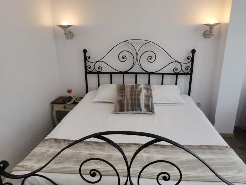 a bedroom with a large bed with a black frame at Family Hotel Rai in Shumen