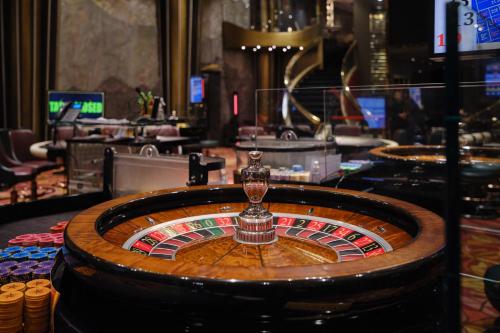 a casino roulette table with a light on top of it at Mayfair Spa Resort & Casino in Gangtok
