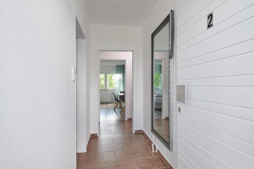 a hallway with a mirror on the wall at RG Living - Pro Comfort in Herford