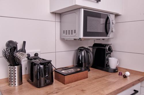 a kitchen counter with a microwave on a counter top at RG Living - Pro Comfort in Herford