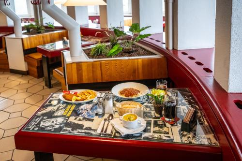 a table with food on it in a restaurant at Hotel und Rasthof AVUS in Berlin