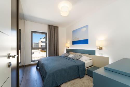 a bedroom with a bed and a large window at The View Luxury Residence with Pool in Zadar