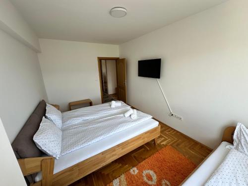 a bedroom with a bed and a flat screen tv at Air Urban in Sarajevo