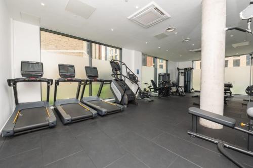 a gym with several treadmills and elliptical machines at The Metalworks in Bristol in Bristol