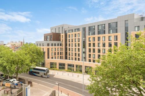 a bus is parked in front of a large building at The Metalworks in Bristol in Bristol