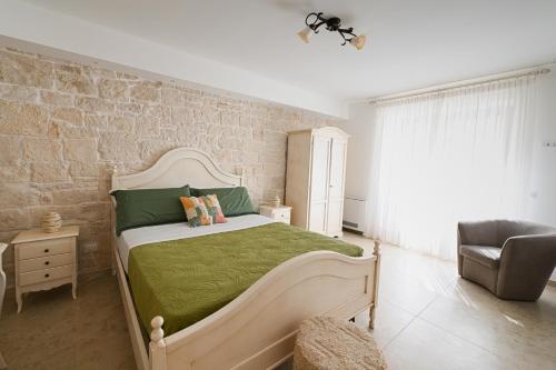a bedroom with a large bed with a green blanket at Dimora Zezzella 