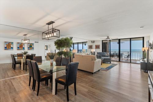 a dining room and living room with a view of the ocean at Beach Club Siesta #104 in Key West