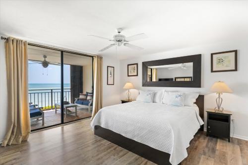 a bedroom with a bed and a view of the ocean at Beach Club Siesta 104 in Key West