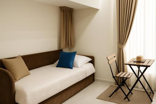 a couch with a blue pillow on it in a room at Station House 45 in Naples