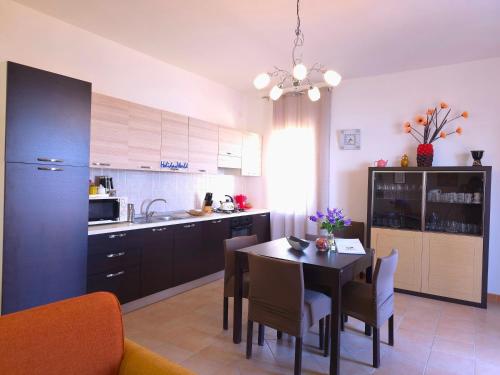 a kitchen with a table and a dining room at Un Soffio dal Mare by Holiday World in Calopezzati