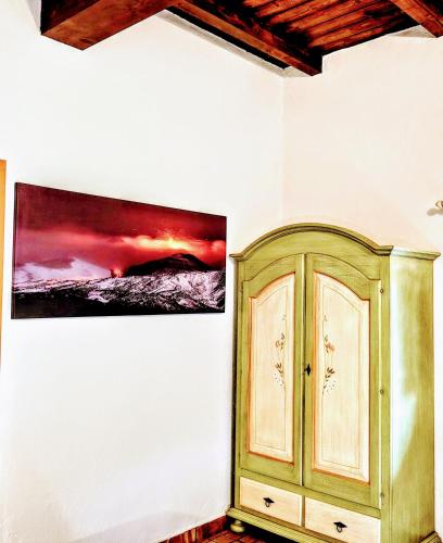 a room with a cabinet and a painting on the wall at Bosco Ciancio in Biancavilla