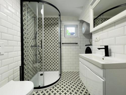 a bathroom with a shower and a toilet and a sink at Vista Mare in Kaštel