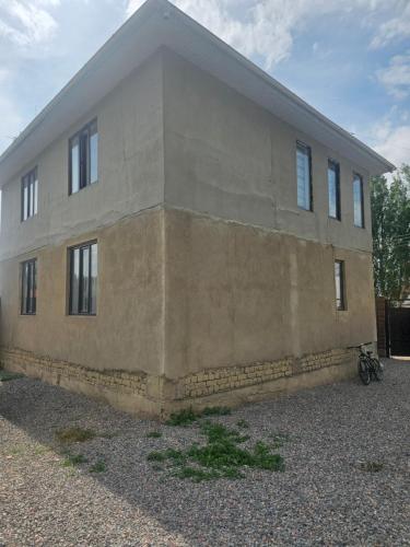 a building with a bike parked in front of it at Нурадил in Akchiy