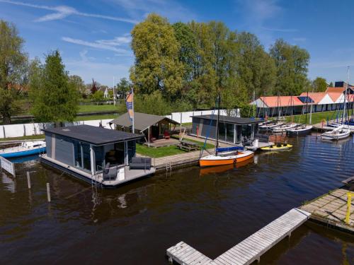 a group of boats are docked at a dock at Safaritent Heeg 4 persoons in Heeg