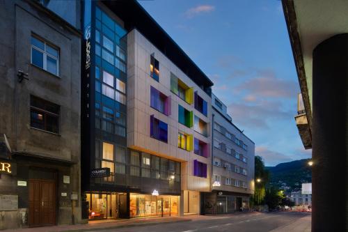 a building with colorful windows on a city street at Hotel Colors Inn in Sarajevo
