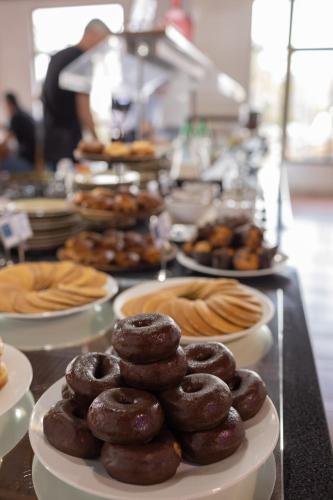 a bunch of donuts on plates on a table at Flag Hotel Madeira - Ribeira Brava in Ribeira Brava