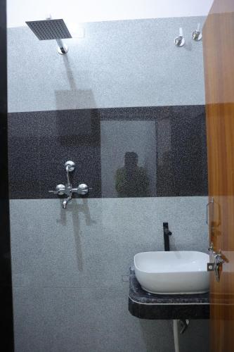 a bathroom with a sink and a mirror at PARADISE GUEST HOUSe in Bikaner