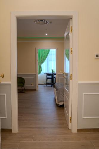 a hallway with a room with a bed and a window at Luxury Acclavio Apartments in Taranto
