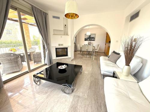 a living room with a couch and a table at Villa Anastasia Sandy Beach Villas - Heated Private Overflow Pool - Games Room - Private Beach Area in Polis Chrysochous