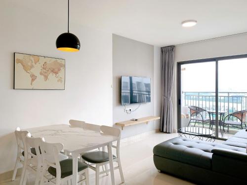 a living room with a table and a couch at The Sun Avenue Serviced Apartment in Ho Chi Minh City