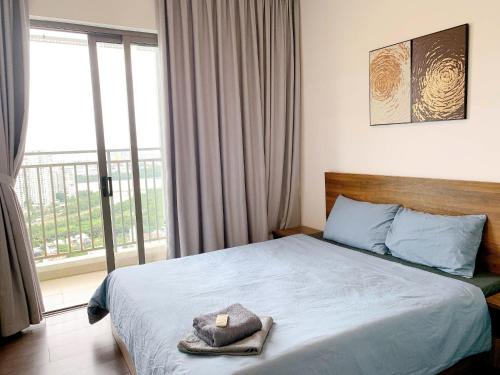 a bedroom with a bed with a candle on it at The Sun Avenue Serviced Apartment in Ho Chi Minh City