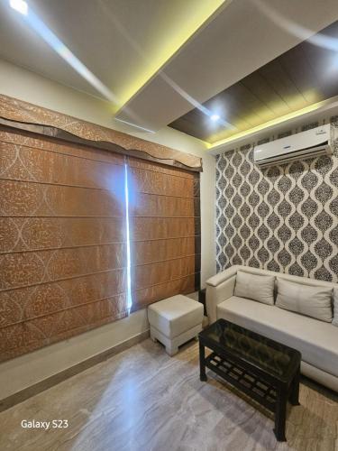 a living room with a couch and a table at Hotel Ramaya in Gwalior