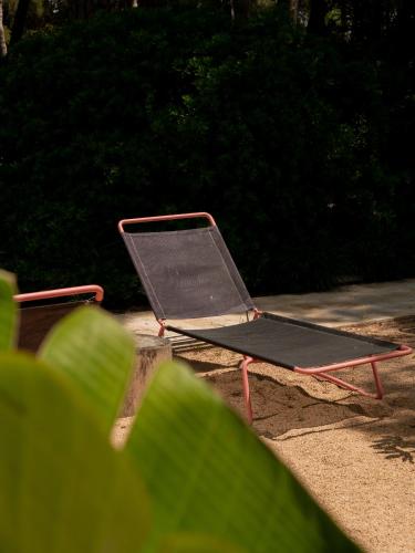 a laptop sitting on a chair in the sand at Hostal Empúries in L'Escala