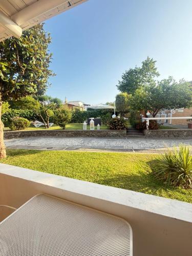 a view of a garden from a porch with a bench at Hotel Parco Delle Agavi in Ischia