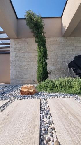 a garden with a stone wall and a stone path at Villa Olive in Labinci
