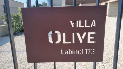 a sign that says villa olive behind a fence at Villa Olive in Labinci