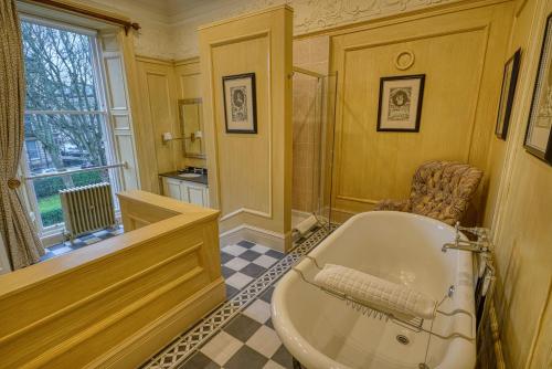 a large bathroom with a tub and a window at Hapimag Resort Edinburgh in Edinburgh
