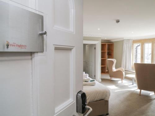 a room with a bed and a living room at Harcombe House Rooms - First Floor King in Newton Abbot