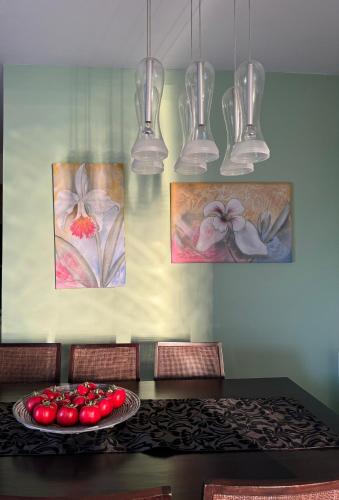 a dining room table with a plate of tomatoes on it at Maison Andre in Pano Lefkara