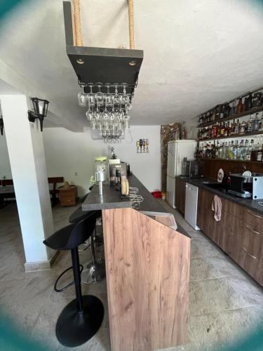 a kitchen with a counter with a bar in it at The Byala Escape, Private Villa with Bar & Hot Tub in Byala