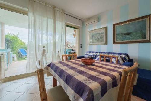 a dining room with a table and a window at Appartamenti Verde Blu in Capoliveri