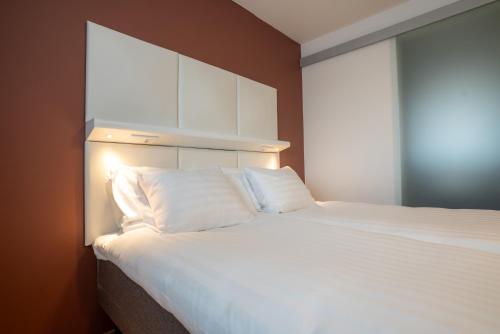 Postel nebo postele na pokoji v ubytování Omena Hotel Hanko
