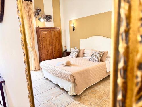 a bedroom with a bed and a mirror at Villa B&B Antiche Macine del Salento - nel cuore del Salento in Salve